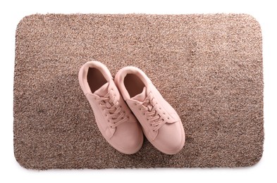 Photo of Stylish door mat with shoes on white background, top view