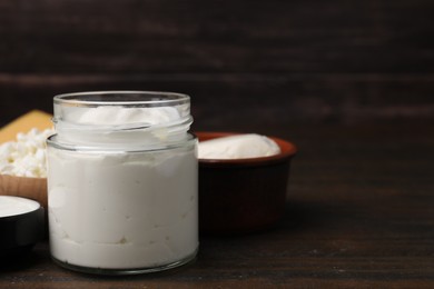 Different fresh dairy products on wooden table, space for text