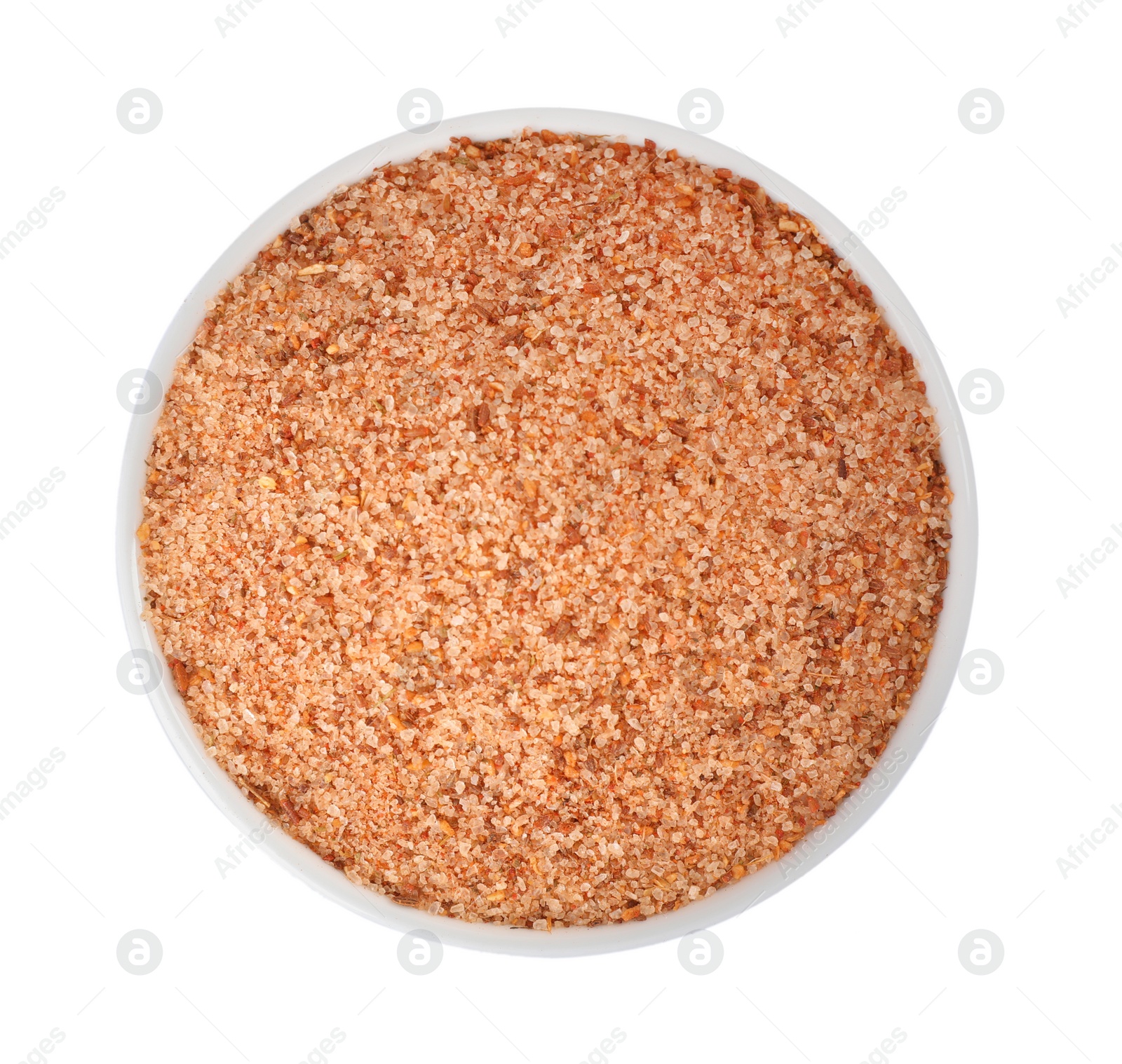 Photo of Pink salt with spices in bowl isolated on white, top view