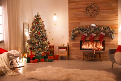 Photo of Stylish room interior with beautiful Christmas tree and decorative fireplace