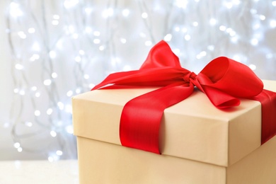 Photo of Beautiful Christmas gift on blurred background, closeup