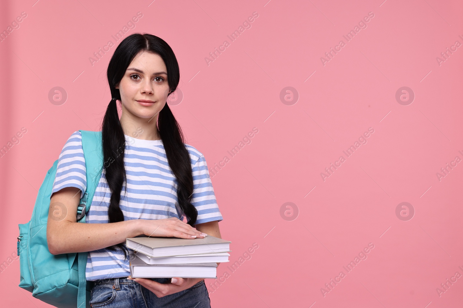 Photo of Student with books and backpack on pink background. Space for text