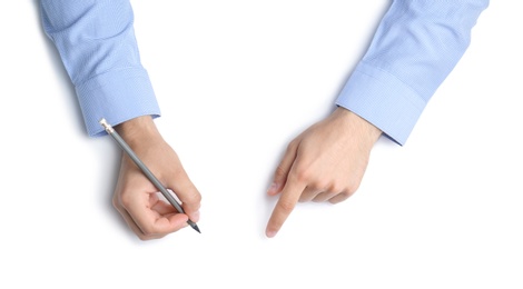 Photo of Man with pencil on white background, top view. Closeup of hands