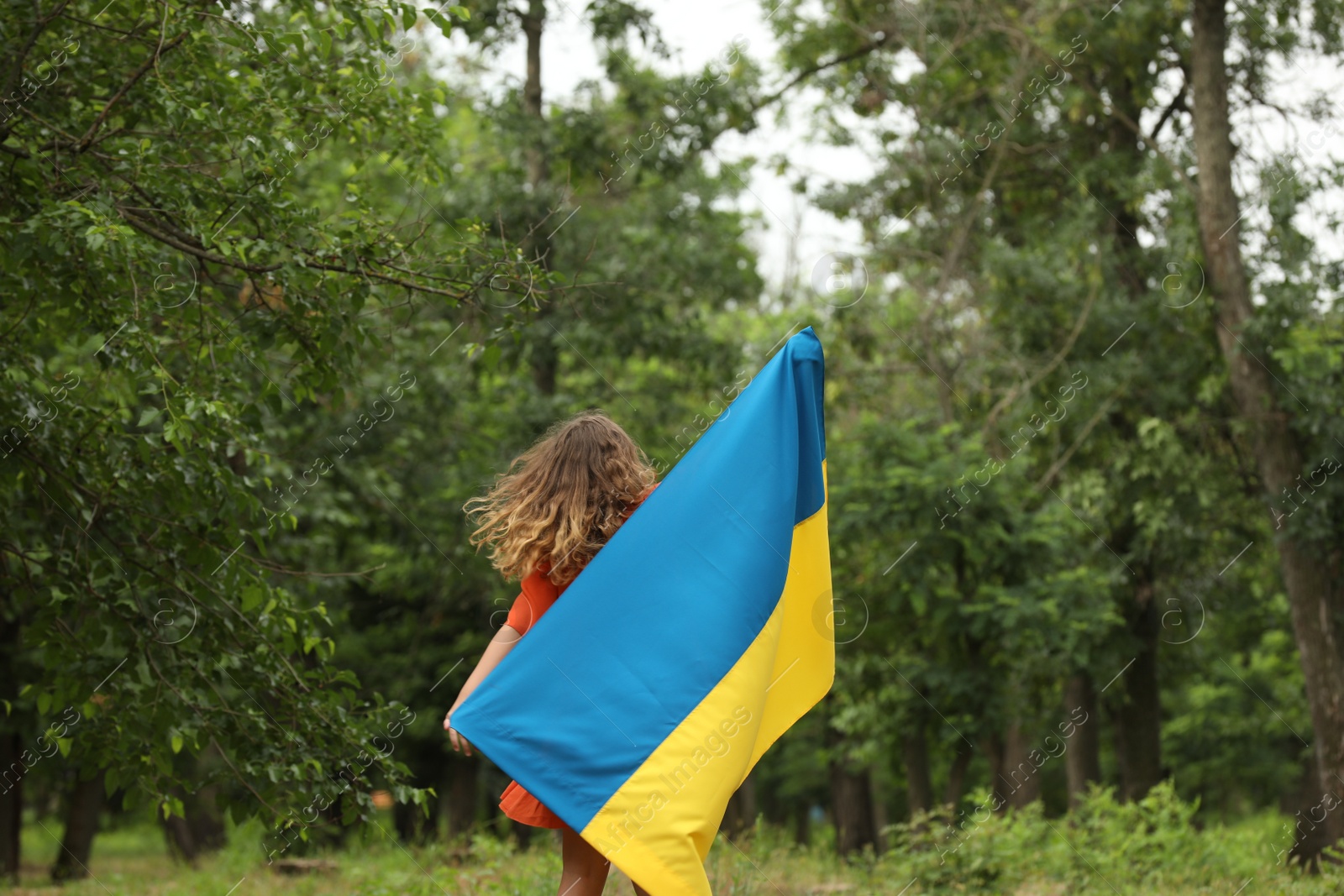 Photo of Teenage girl with flag of Ukraine outdoors