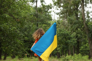 Photo of Teenage girl with flag of Ukraine outdoors
