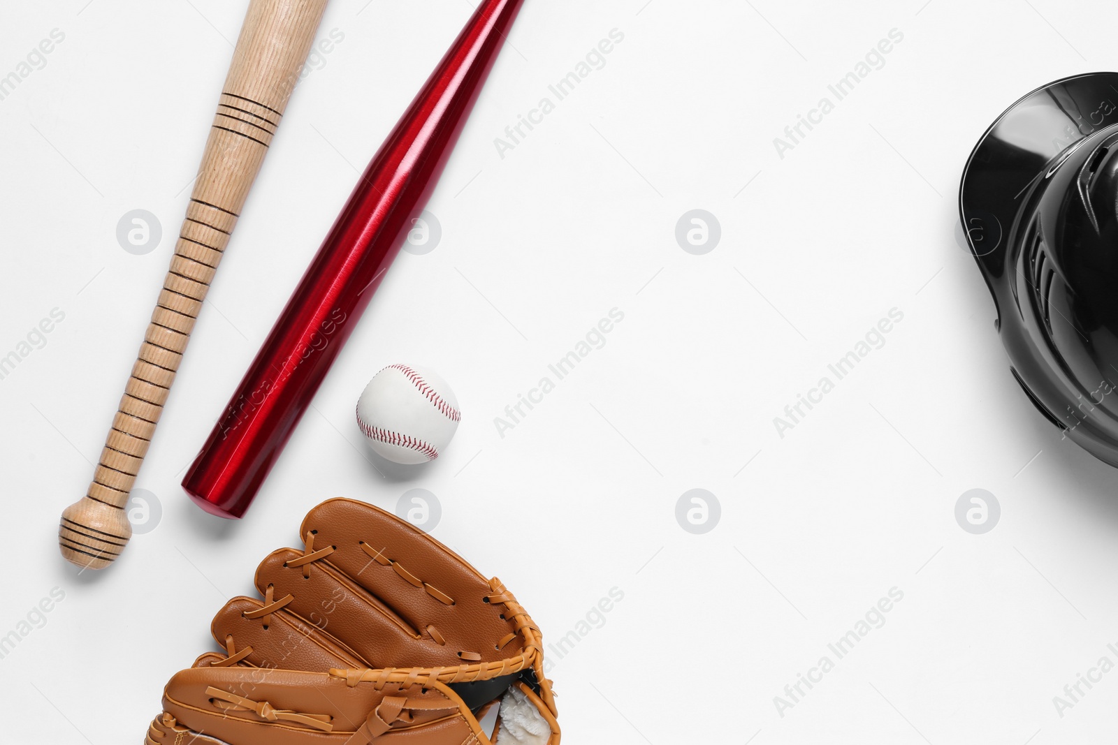 Photo of Baseball glove, bats, ball and batting helmet on white background, flat lay. Space for text