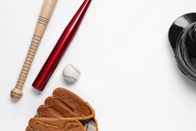 Baseball glove, bats, ball and batting helmet on white background, flat lay. Space for text