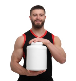 Photo of Young man with muscular body holding jar of protein powder on white background