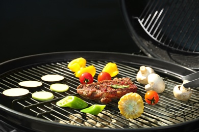 Photo of Tasty steak and vegetables on modern barbecue grill, closeup