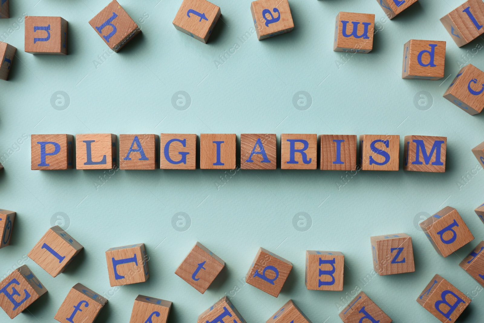 Photo of Wooden cubes with word Plagiarism on turquoise background, flat lay