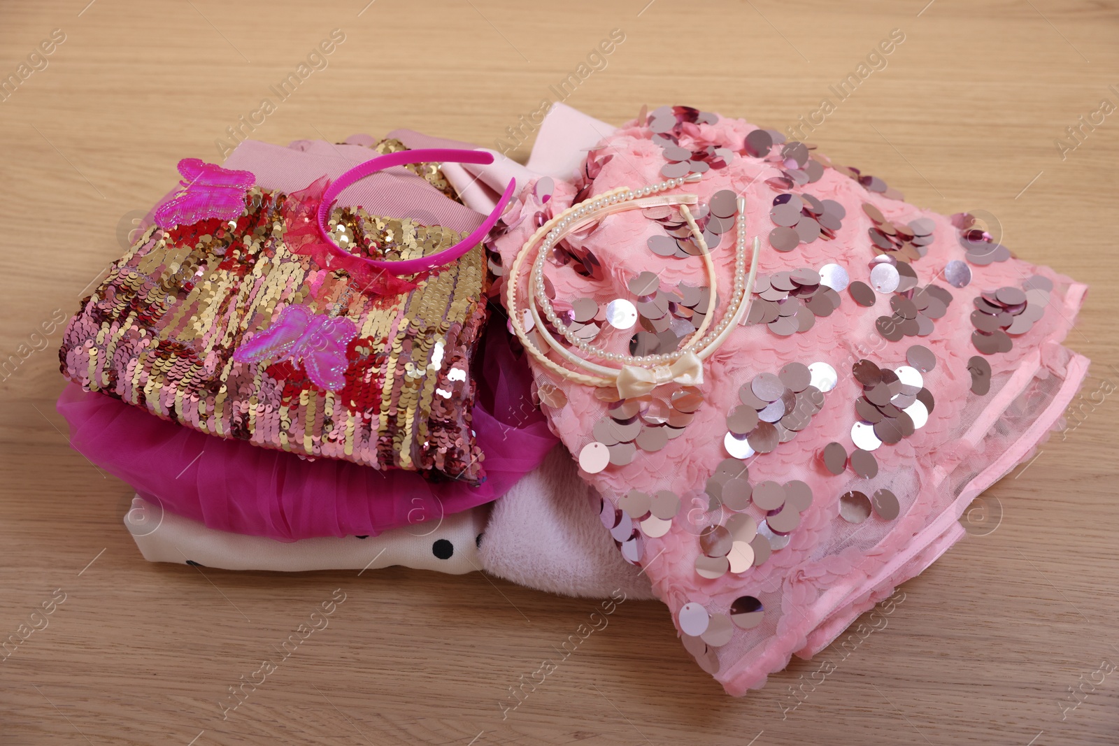 Photo of Stylish carnival costume with sequins and headbands on wooden table