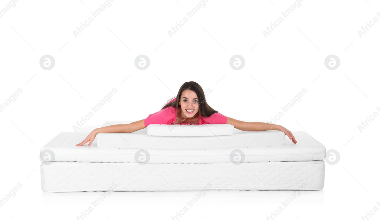 Photo of Young woman lying on mattress pile against white background