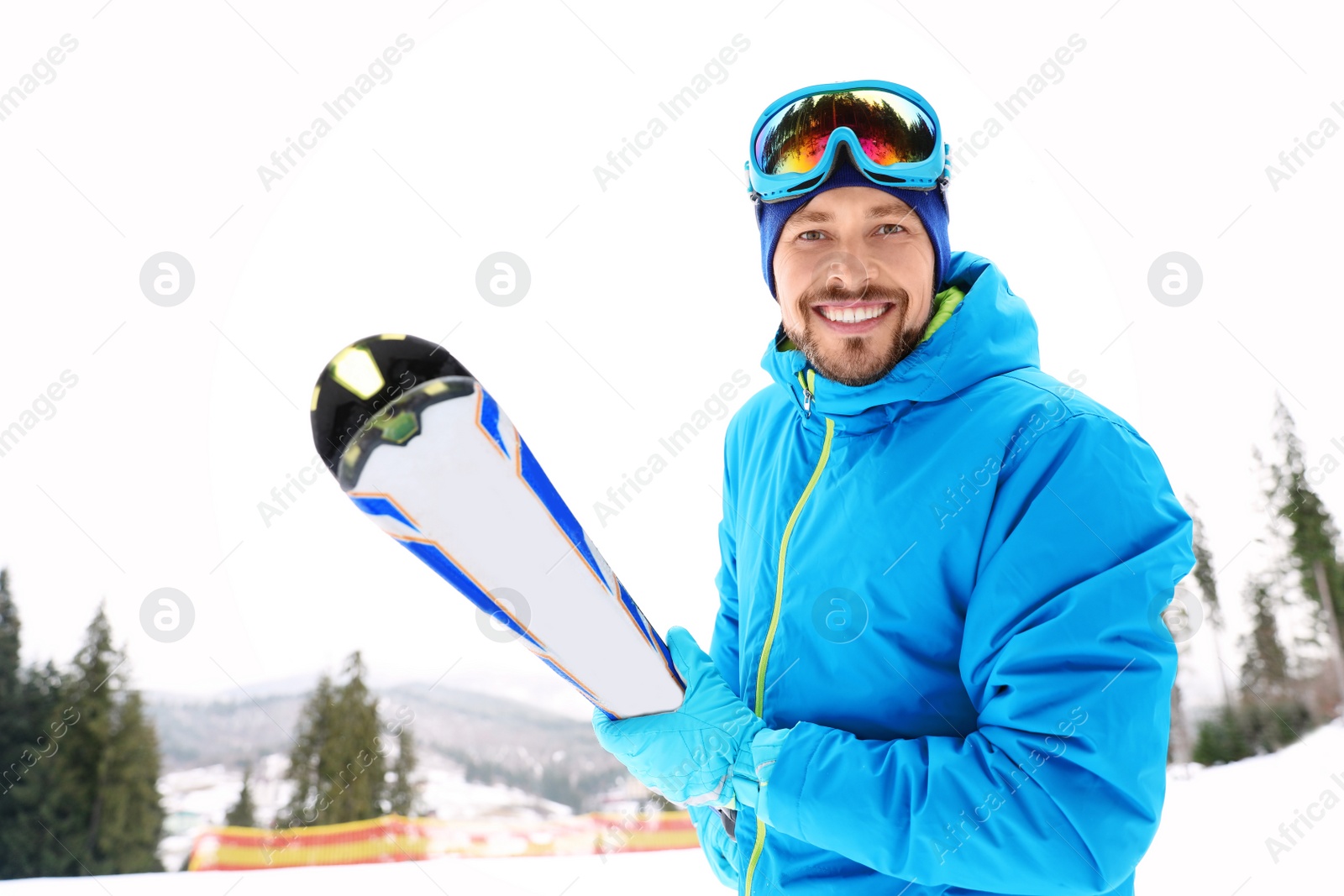 Photo of Male skier on slope at resort. Winter vacation