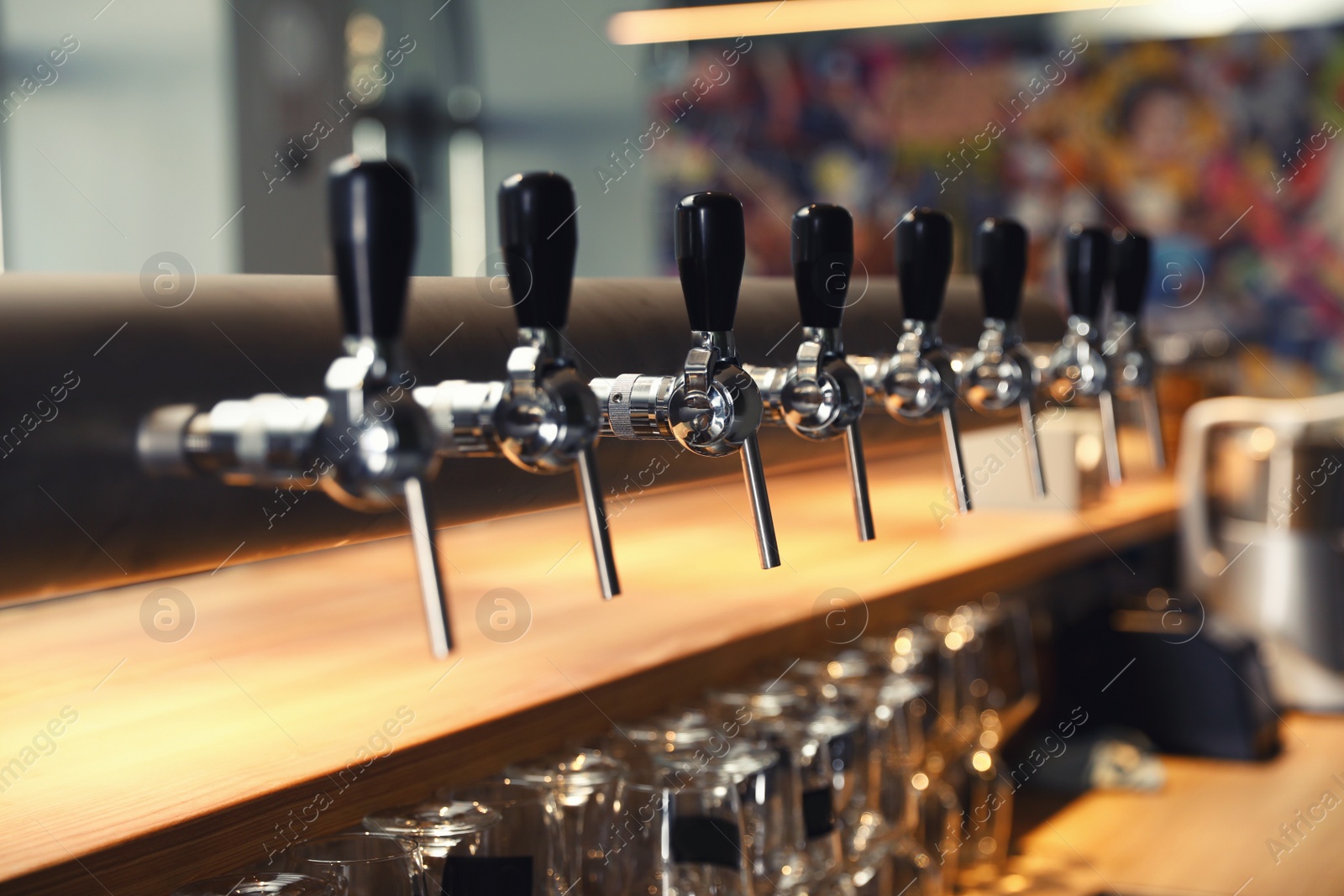 Photo of Row of shiny beer taps in pub