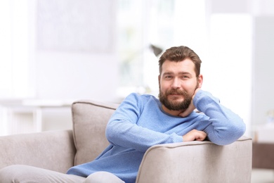 Photo of Portrait of confident mature man in armchair