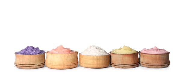 Different body scrubs in bowls on white background