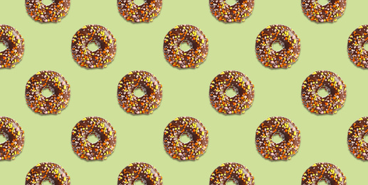 Image of Creative pattern design of glazed donuts on pale light green background, banner