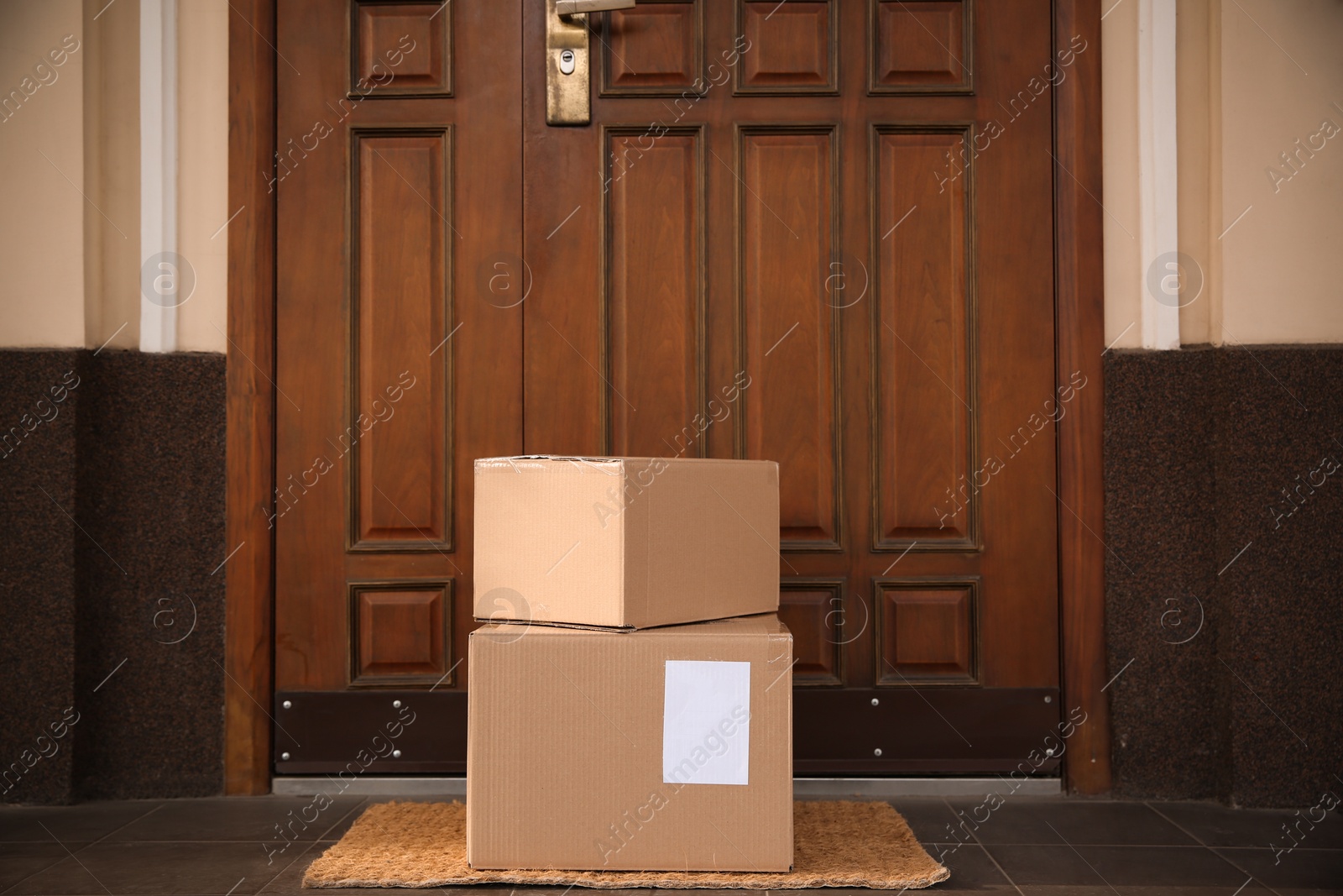 Photo of Delivered parcels on door mat near entrance