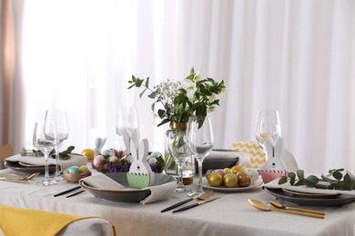 Photo of Beautiful Easter table setting with festive decor indoors