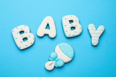 Word BABY made of tasty cookies on light blue background, flat lay