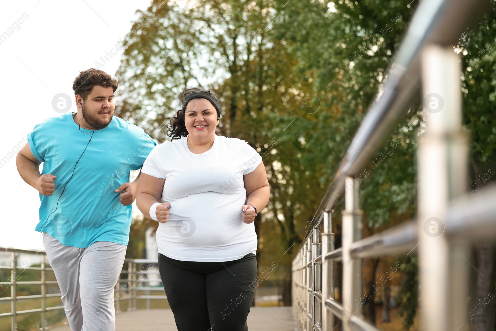 Photo of Overweight couple running together in park