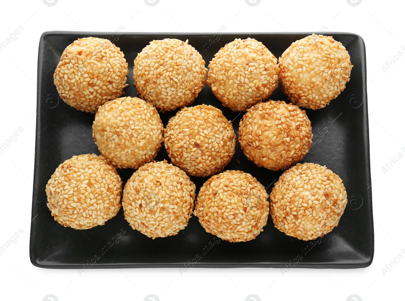 Photo of Many delicious sesame balls on white background, top view