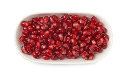 Photo of Ripe juicy pomegranate grains in bowl isolated on white, top view