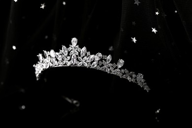 Beautiful silver tiara with diamonds on black cloth