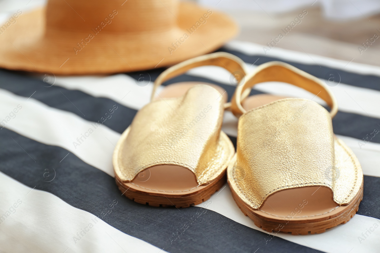 Photo of Stylish female shoes on striped fabric, closeup