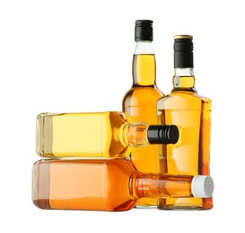 Different sorts of whiskey in glass bottles isolated on white