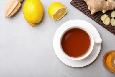 Flat lay composition with cup of tea and space for text on grey background. Cough remedies