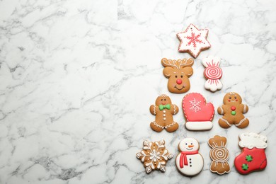 Photo of Christmas tree shape made of delicious gingerbread cookies on white marble table, flat lay. Space for text
