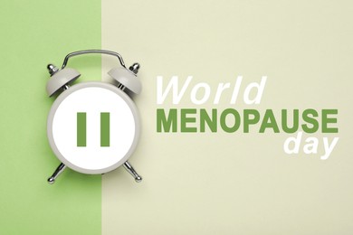 Image of World Menopause Day. Alarm clock with pause symbol on color background, top view