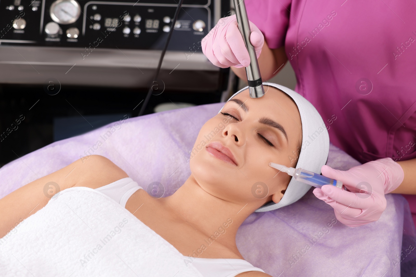 Photo of Young woman undergoing cosmetic procedure in beauty salon. Microcurrent therapy