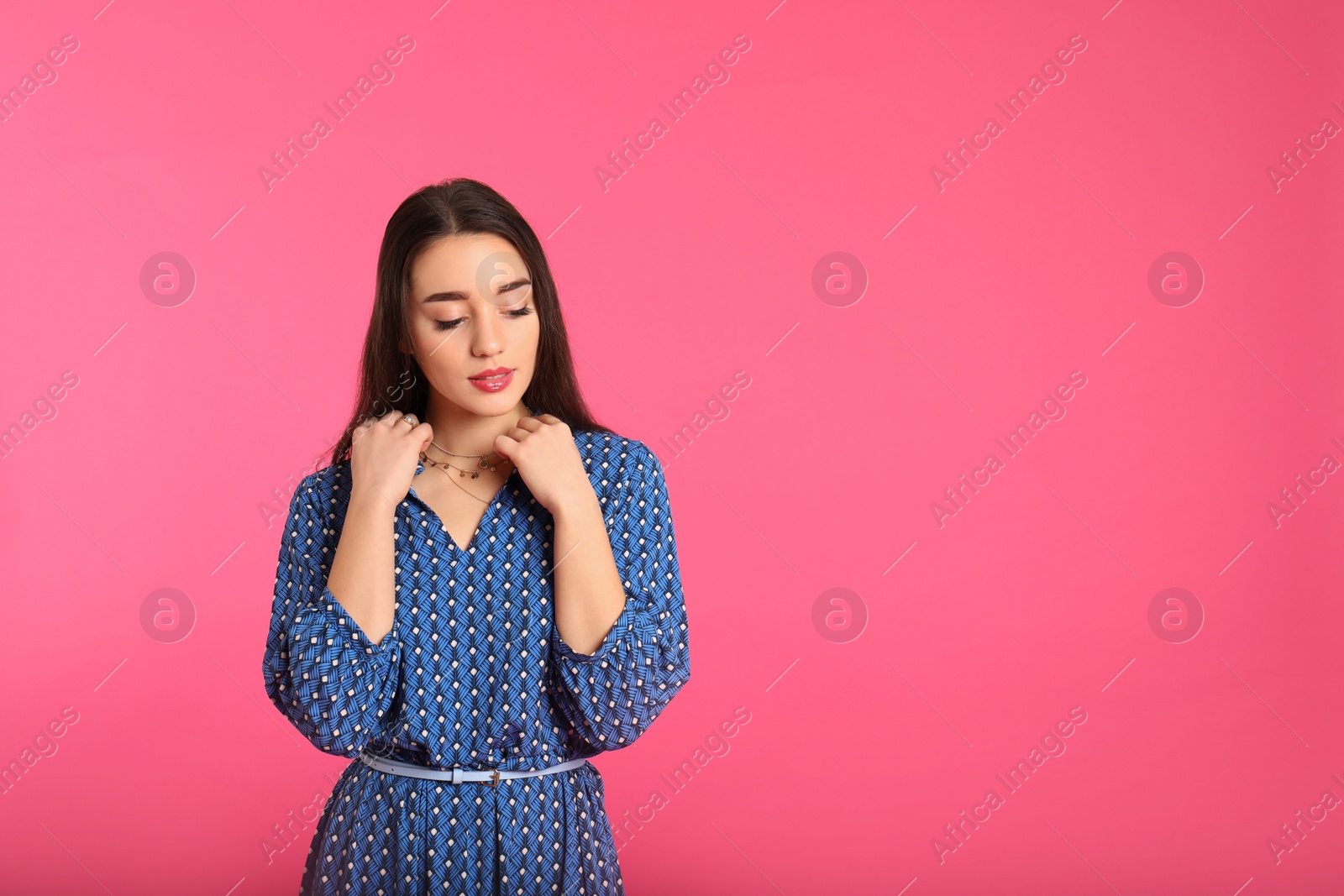 Photo of Portrait of beautiful young woman in stylish dress on color background. Space for text