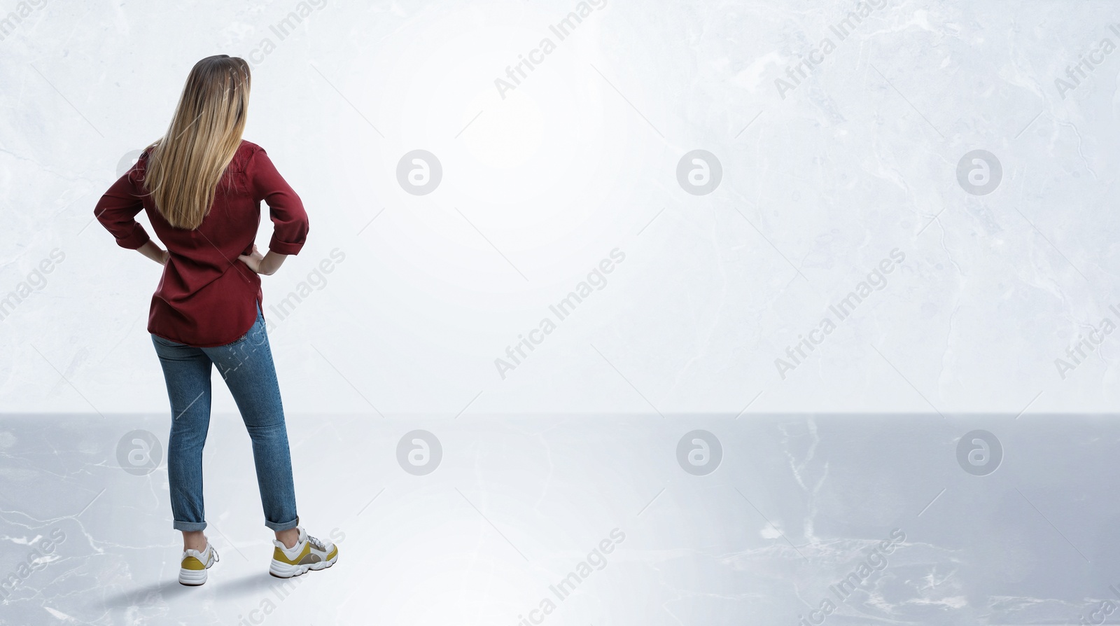 Image of Woman standing in front of light marble wall, back view. Banner design with space for text