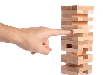 Photo of Playing Jenga. Man building tower with wooden blocks on white background, closeup