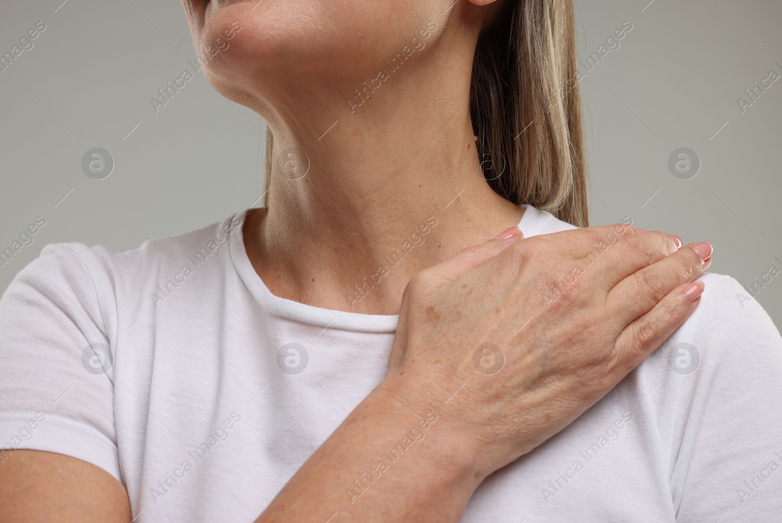 Photo of Mature woman with healthy skin on grey background, closeup