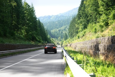 Picturesque view of asphalt road with modern car outdoors