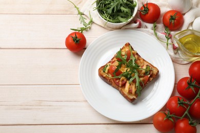 Tasty pizza toasts and ingredients on light wooden table, flat lay. Space for text