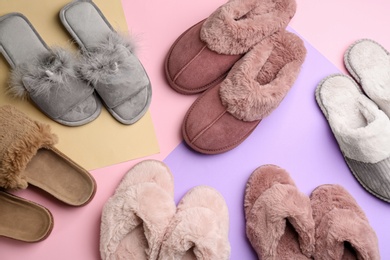 Many different soft slippers on color background, flat lay