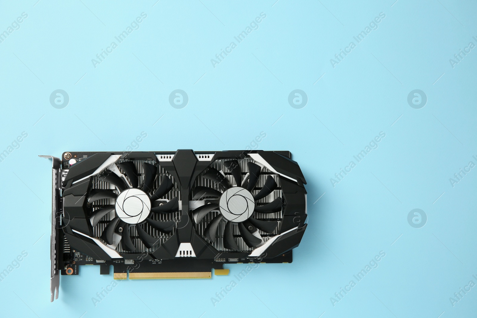 Photo of Computer graphics card on light blue background, top view. Space for text