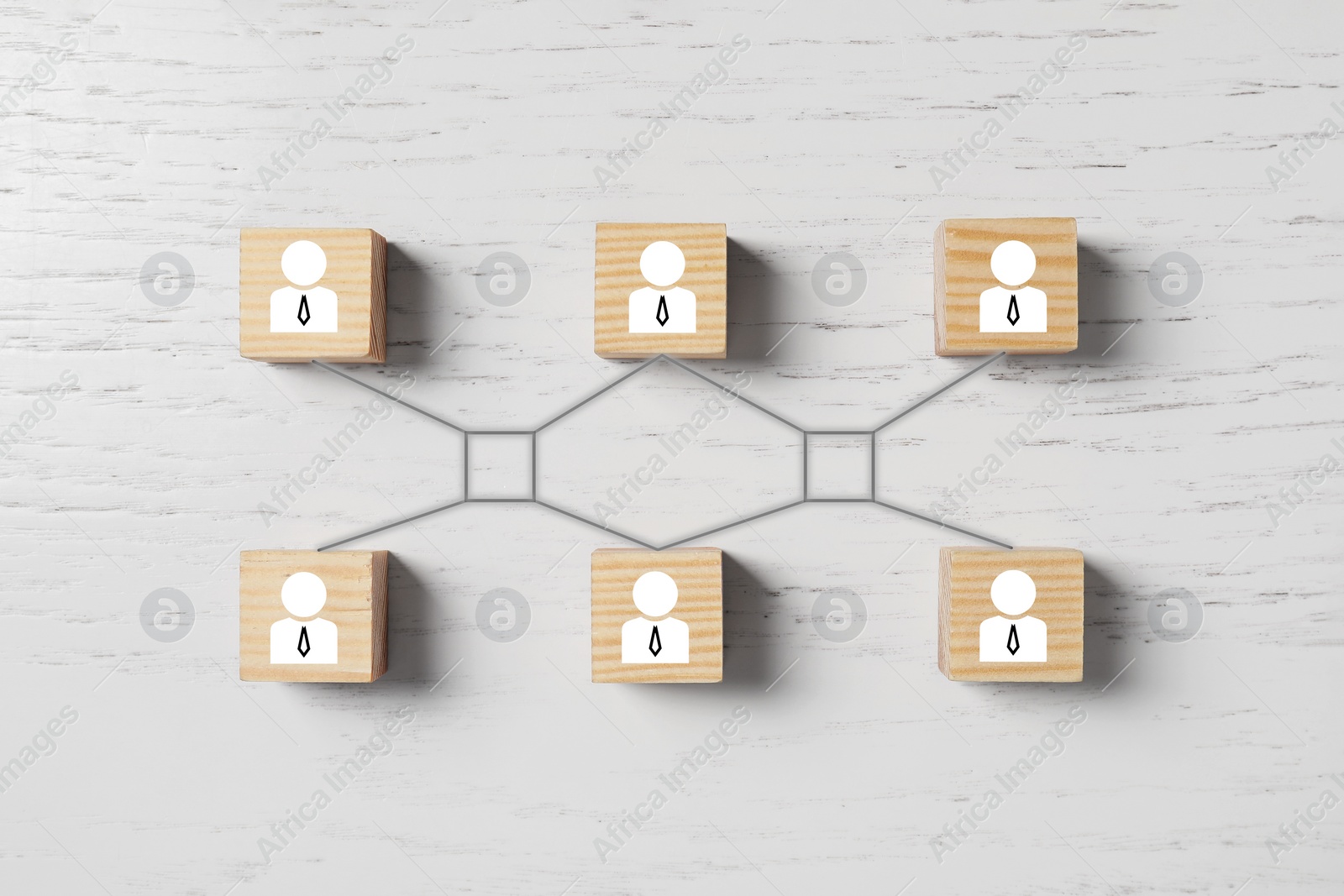 Image of Teamwork. Cubes with human icons linked together symbolizing cooperation on white wooden background, top view