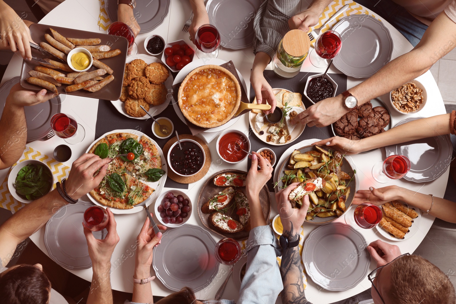 Photo of Group of people having brunch together at table indoors, top view