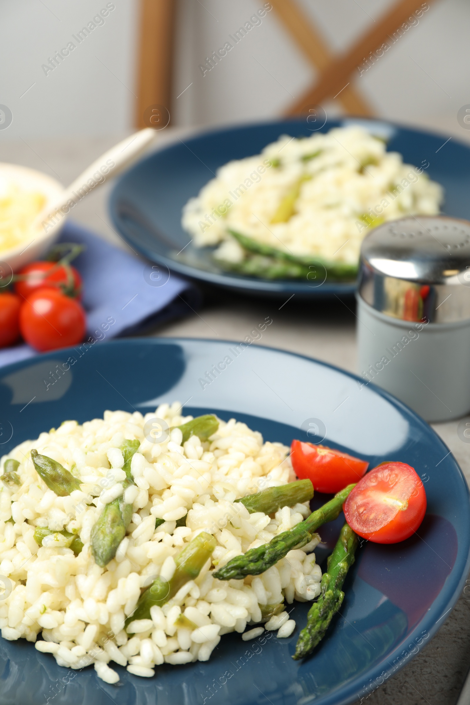 Photo of Delicious risotto with asparagus on table, closeup