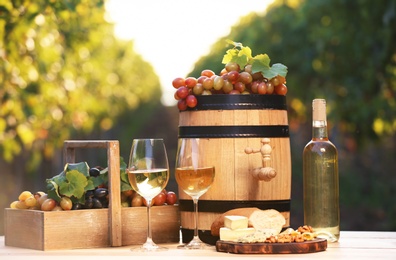 Photo of Composition with wine and snacks on table outdoors