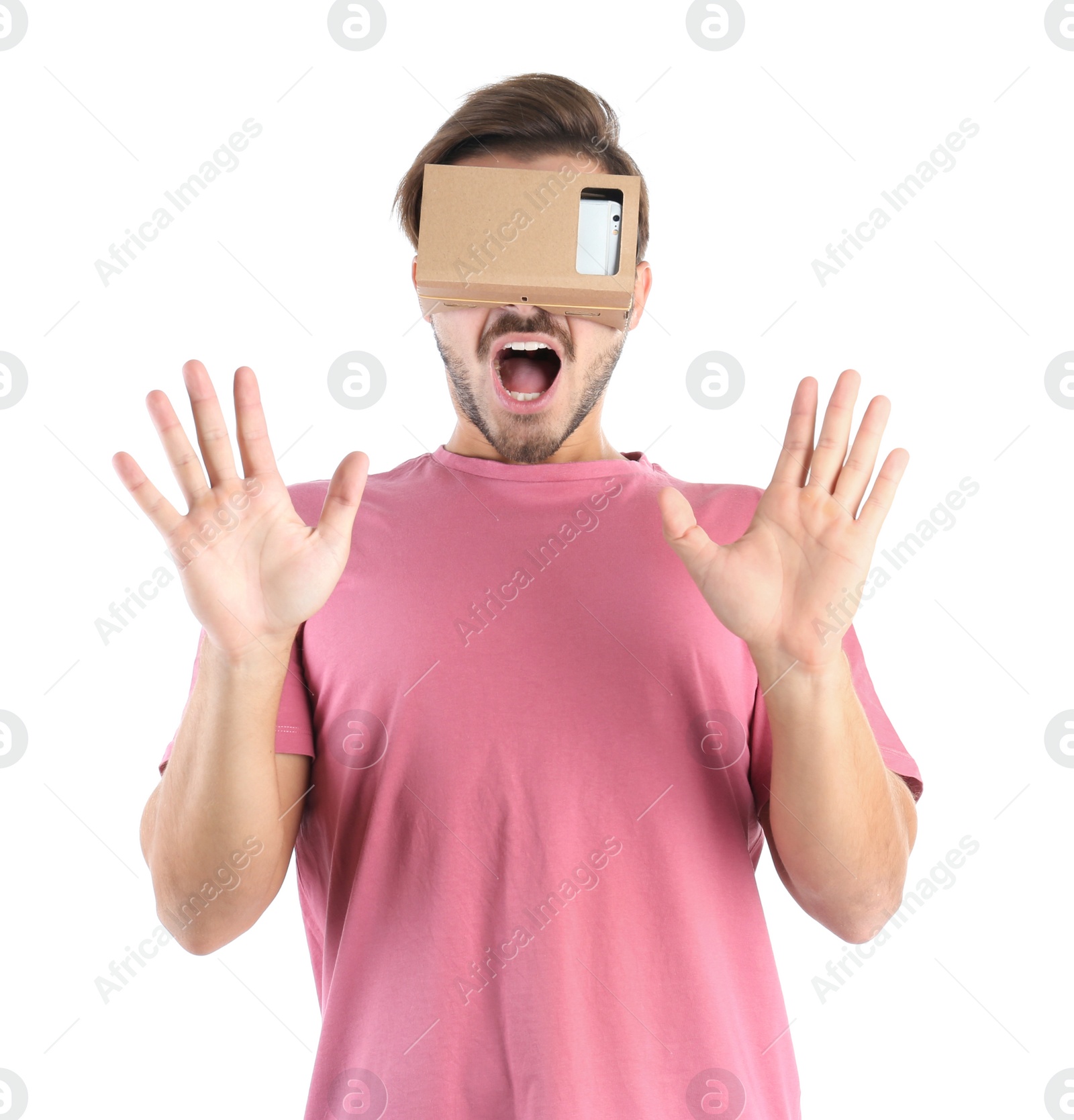 Photo of Young man using cardboard virtual reality headset, isolated on white