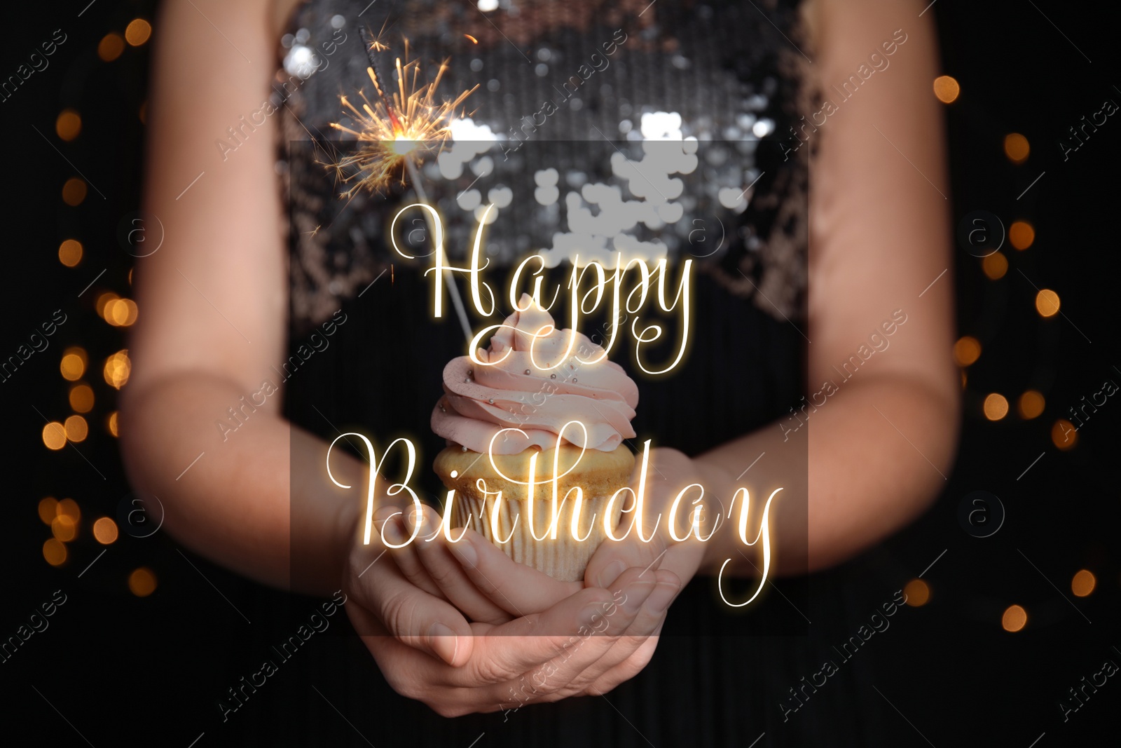 Image of Woman holding tasty cupcake with sparkler on blurred background, closeup. Happy Birthday greetings