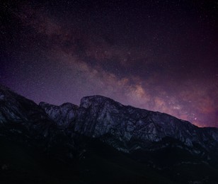 Image of Picturesque view of starry night sky over mountains