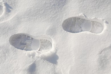 Photo of Bootprints on snow outdoors, top view. Winter season